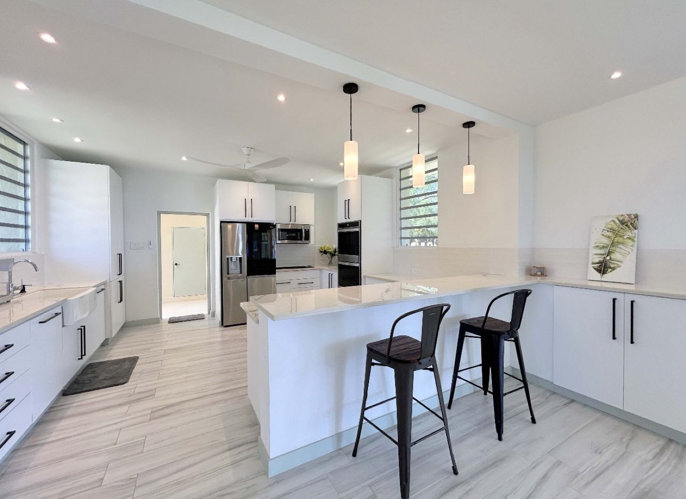 Bright kitchen with a long counter and appliances